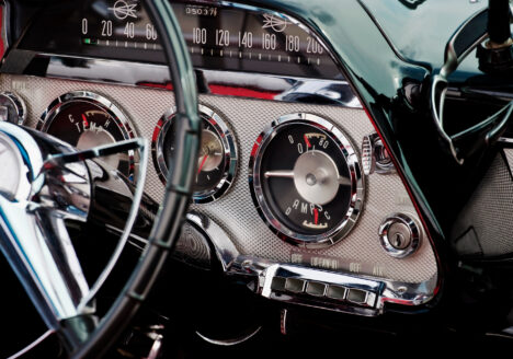 The interior of a classic car, showing the dashboard and steering wheel